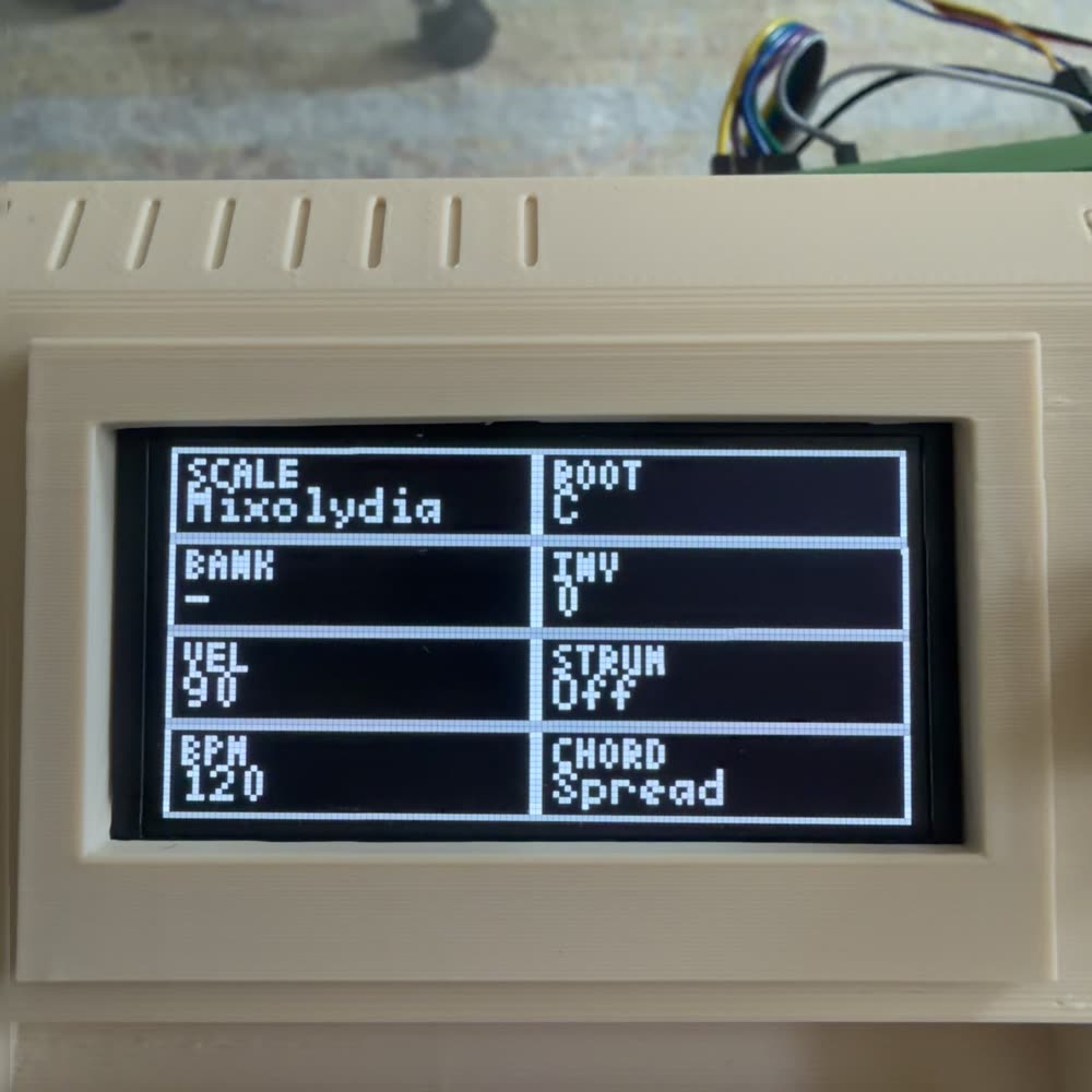 Close-up of the R1C1 OLED showing SCALE Mixolydian, ROOT C, BANK, INV 0, VEL 90, STRUM Off, BPM 120, CHORD Spread.